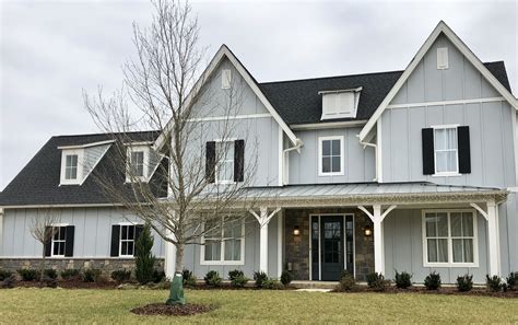 gray house black metal roof|grey house with black awnings.